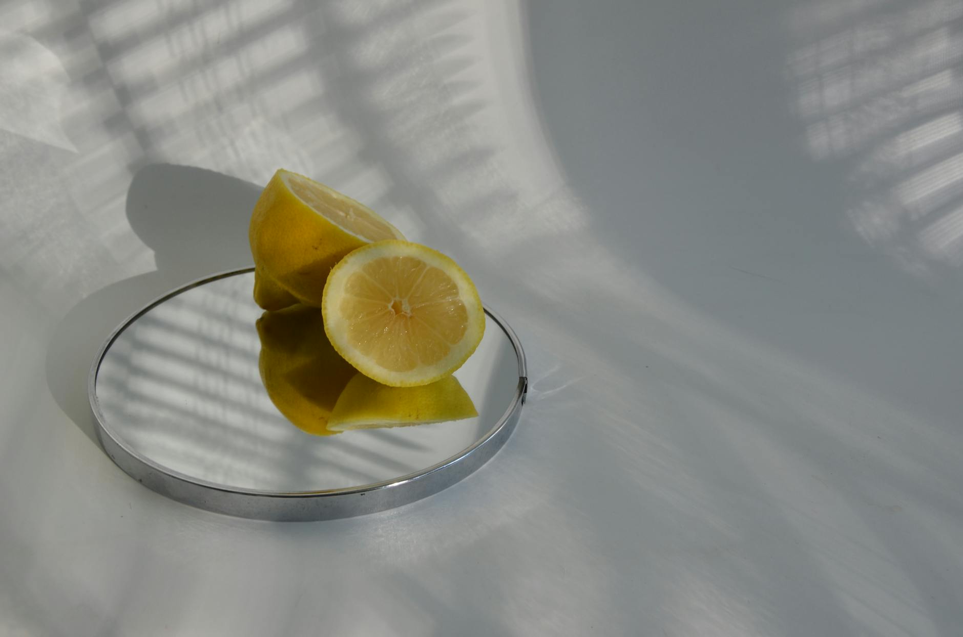Sliced lemons on a mirror, illustrating the sensitive tissue changes that happen during hormonal transitions