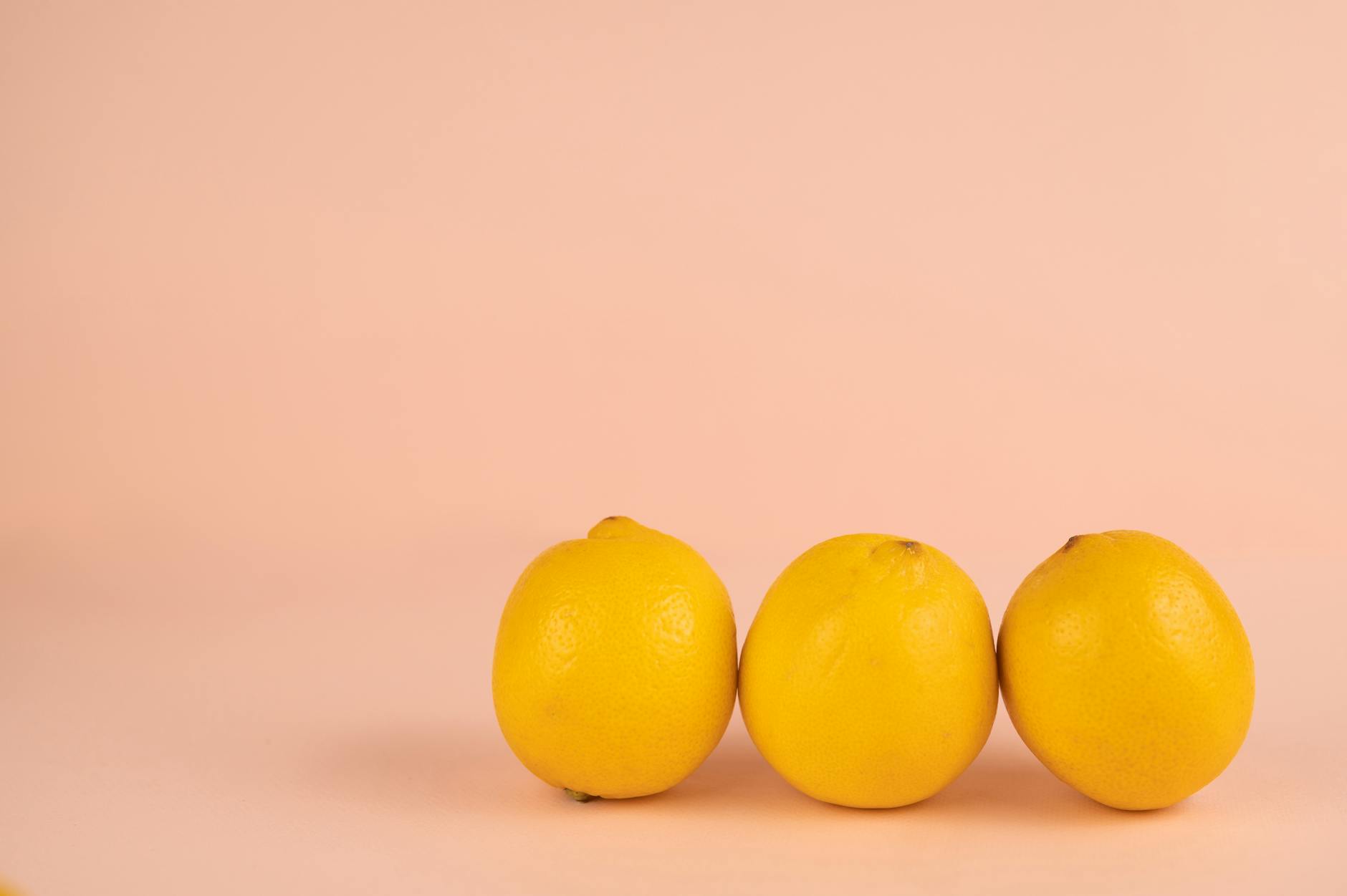 Bright ripe lemons on a pastel background, symbolizing patience and natural timing
